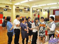 Participants asking a Hong Kong teacher (right) questions during a school visit in Hong Kong